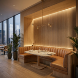 Restaurant booth with natural oak acoustic slat wall panel and warm LED lighting