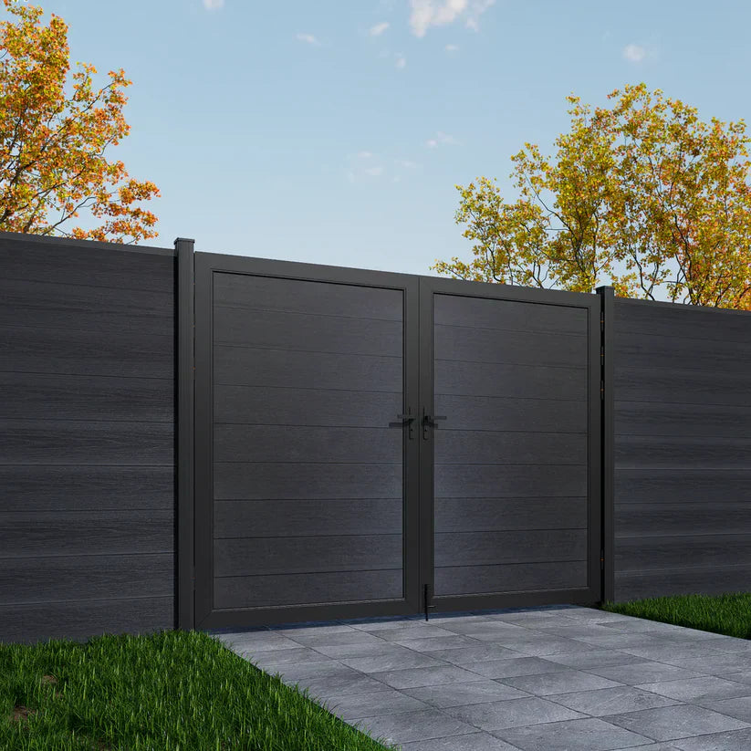 Dark gray wooden gate with matching fence in a garden setting