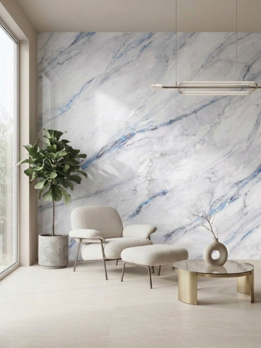 3D Bluewave PVC marble sheets covering a living room accent wall behind a cream chair and ottoman