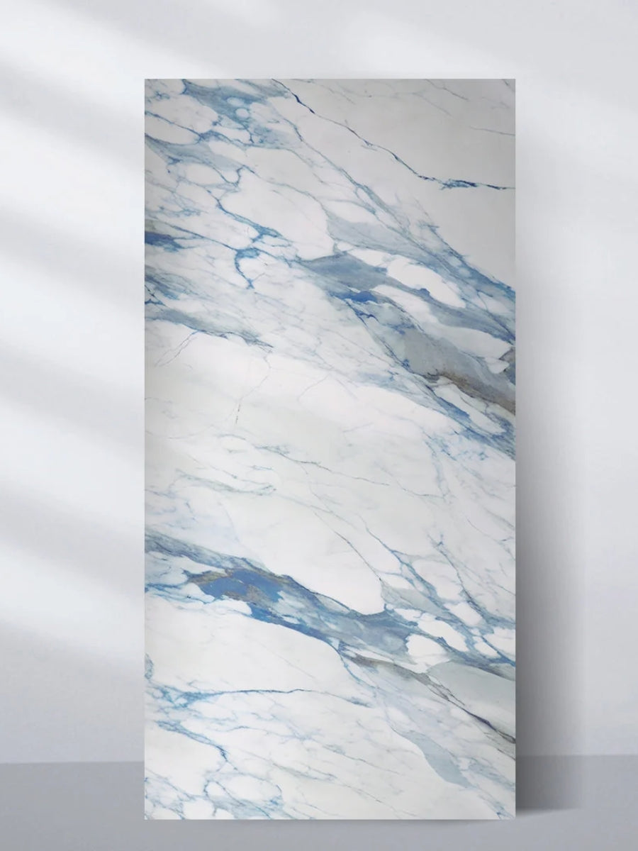 4x8 ft 3D Calacatta Azur PVC wall panel with flowing blue and gray veining on a white marble-look surface