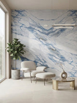 Calacatta Azur marble-look PVC wall panels installed behind a lounge chair and ottoman