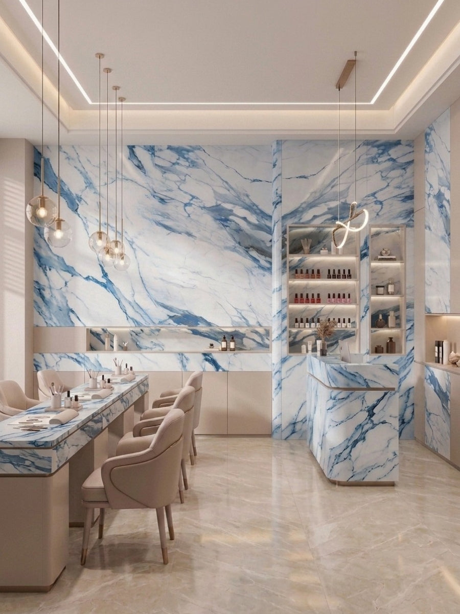 Contemporary salon interior clad in Calacatta Azur PVC panels with bold blue marble veining