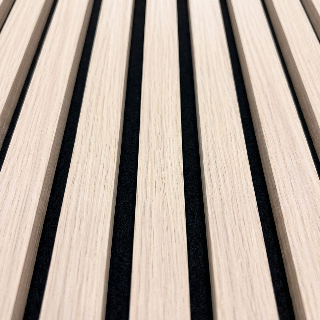 Close-up of natural oak acoustic slat wall panel with black felt backing