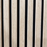 Close-up of oak acoustic slat wall panel with black felt backing