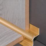 Gold aluminum inside corner trim cross-section showing how panel edges fit into the profile