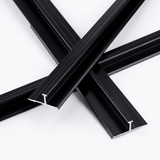 Overlapping black aluminum alloy H trim lengths with visible channel profiles