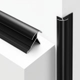 Black aluminum alloy round outside corner trim shown in cross-section and fitted vertically on a white corner