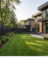 Black full privacy fence surrounding a landscaped backyard at a modern home
