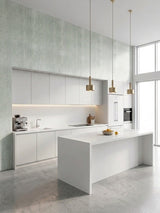 Pale green textured PVC wall panels surrounding a minimalist white kitchen
