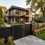 Modern house with a black metal gate and well-maintained garden