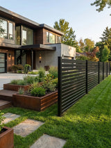 Black aluminum semi privacy fence installed along a landscaped lawn beside a modern home