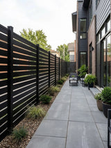 Black horizontal-slat aluminum semi privacy fence lining a paved side patio