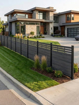 Black composite privacy fence with lattice top installed along the landscaped front yard of a modern home