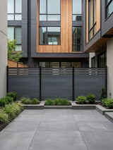Light gray top lattice privacy fence enclosing a landscaped modern courtyard