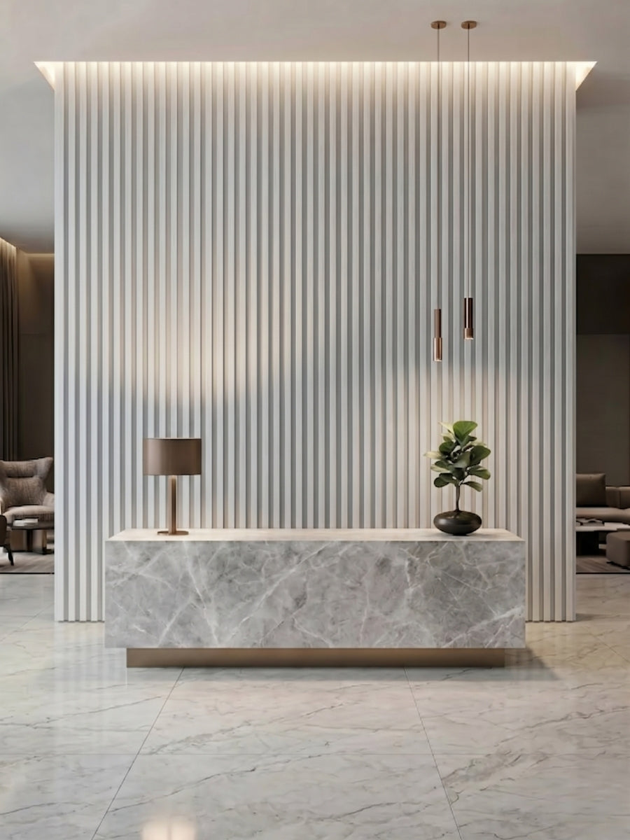 White brushed WPC fluted 3D wall panels behind a marble-look reception desk with pendant lights