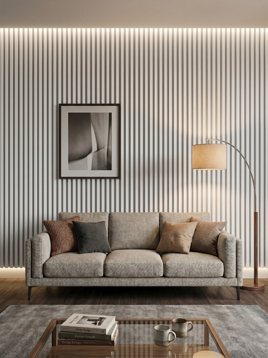 White brushed WPC fluted 3D wall panels installed behind a gray sofa in a modern living room