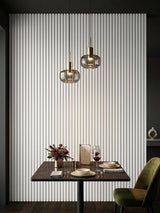 White WPC fluted 3D wall panels creating a vertical accent wall behind a dining table and pendant lights