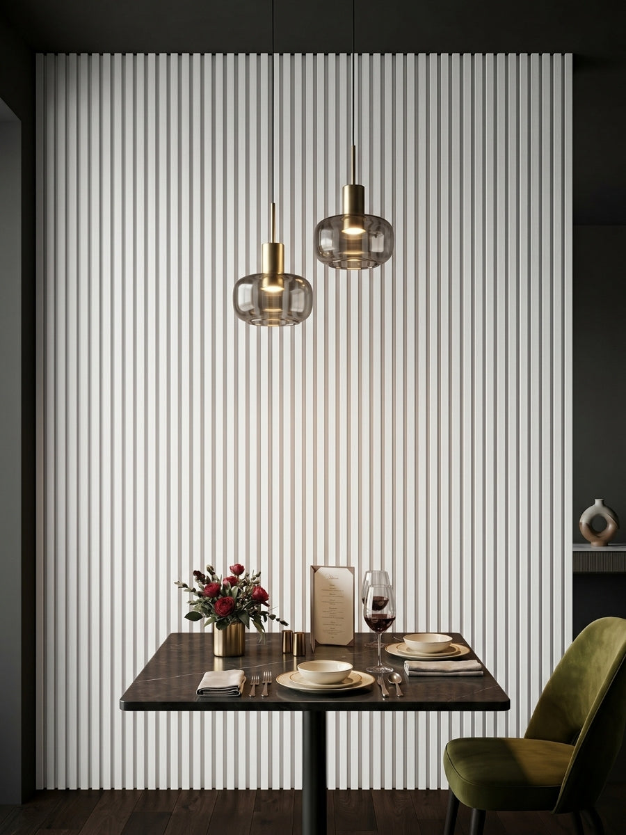 White WPC fluted 3D wall panels creating a vertical accent wall behind a dining table and pendant lights