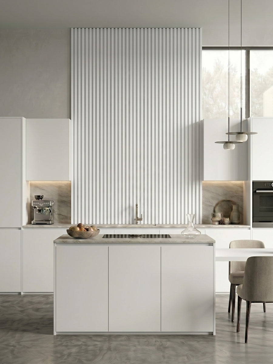 White brushed WPC fluted wall panels installed as a tall feature wall in a modern white kitchen