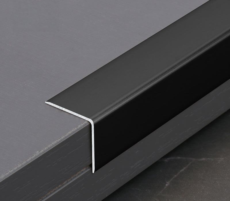 Black aluminum wall panel trim L cap fitted over the edge of a dark panel