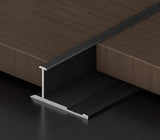 Black 3mm aluminum H-joint connection trim fitted between dark wood-look wall panels