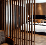 Dark brown WPC timber tubes, 4x2 inches, 9.5 feet long, used in stylish wooden slatted bedroom partitions in NJ.