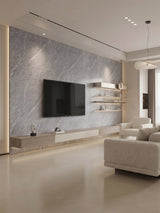 Modern living room with an ash gray marble PVC feature wall, mounted TV, and floating shelves