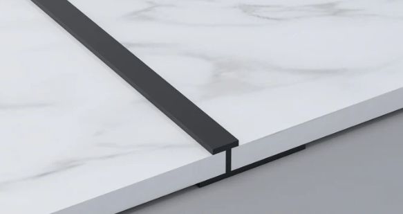 Black 3mm aluminum H-joint trim connecting two white marble-look PVC wall panels
