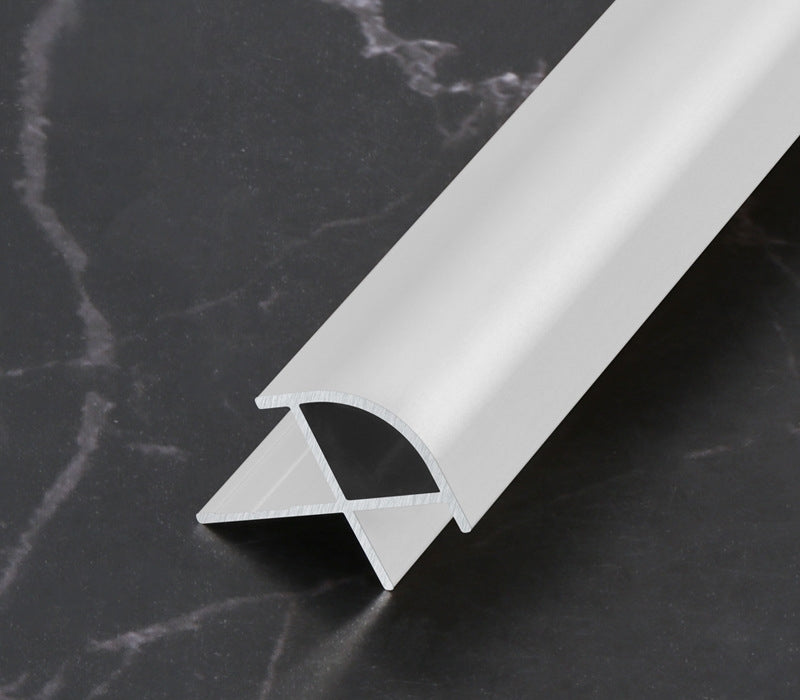 Silver 3mm aluminum outside corner trim with rounded face on a dark marble surface