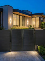 WPC Fence Gate Double 6ft x 6ft with black wood-grain panels and matching frame, installed at a modern home entrance with outdoor lighting at dusk.