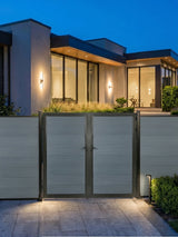 WPC Fence Gate Double 6ft x 6ft with gray horizontal panels and black metal frame, installed at a modern home with outdoor landscape lighting.