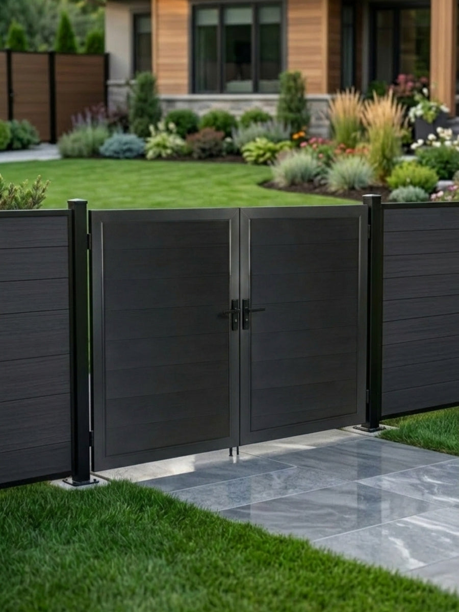 8ft x 6ft black WPC double fence gate with horizontal panels installed along a landscaped backyard garden