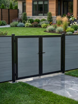 8ft x 6ft gray WPC double fence gate with black frame and horizontal panels installed along a landscaped backyard