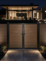 8ft x 6ft WPC double fence gate with brown horizontal panels and black frame illuminated outside a modern home at night
