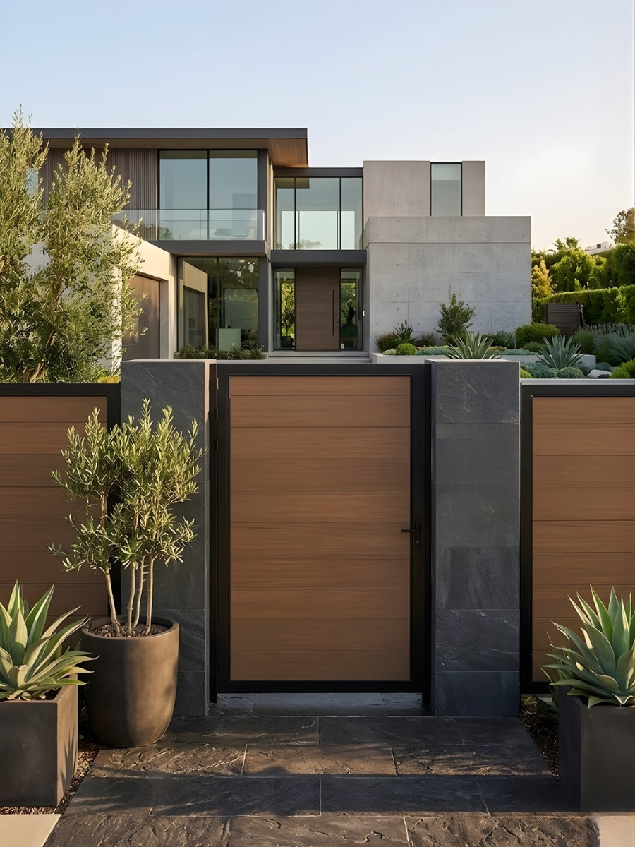 Brown wood-grain WPC Fence Gate Single 4ft x 6ft with black metal frame installed between matching fence panels at a modern landscaped home.